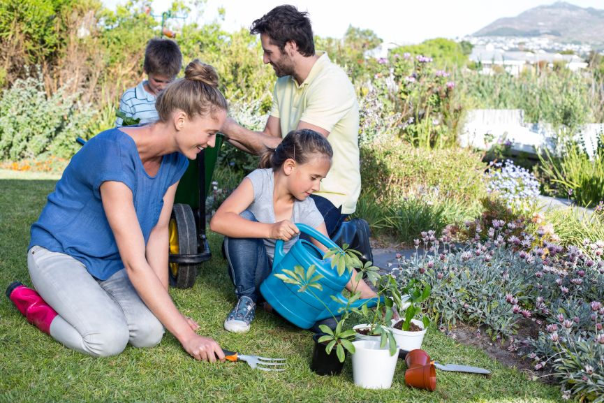 Family gardening together teaching kids about nature